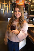 I got the black one first and loved it so much that I got the blush as well. The shoulders stay down well. I was able to wear this all day on a wine-tasting tour and never had to adjust it. It's super flattering for a sweater and very comfortable. - Jessica K.