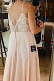 Has fit everyone in the bridal party even those with a large bust. Fits true to size, but it's long so I'll have to take it to a seamstress. I couldn't button it all the way alone, so the photos don't do it justice. - Elisabeth A.