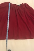 So unhappy with this purchase, and I can't return or exchange. I guess I know why it was on clearance now. Color is not as pictured. It's more burgundy than red. Length is cropped, and sleeves are very tight at the wrist where it buttons. Neck is also tiny. Super uncomfortable fit. Also, very sheer; you would have to wear something under it. Nowhere in the description does it say cropped but it is and is super boxy. Very disappointed - Jennifer K.