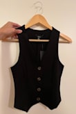 It really looks like a custom fit on me! I am rarely impressed by clothing but this vest looked so perfect on me that I had to leave a review. I definitely recommend you have a thinner frame and a smaller waist for this to look amazing on you! I am on the slimmer side. - Lillybeth D.