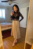 Beautiful champagne color, just as pictured! Looks great with both light and dark tops. As other reviewers noted, the length can be easily adjusted by rolling the waistband inward. Can't wait to wear it to some upcoming holiday parties! - Joy I.