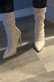 These boots are a cute pearly color. They do feel a bit slippery but could also be cause they're new lol. Definitely recommend them if you're used to boots/heels with a thin heel. For reference, I straddle between a 7.5-8. These are 7.5 and a bit tight at the toes but not tight enough to exchange cause I know after a few wears it'll loosen up to fit just right. - Janneth R.