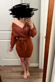 Definitely a little on the tighter & shorter side but I really like it. The belt distracts from the tightness in the front and it's fun to wear as a fall sweater dress. Pairs well with over-the-knee boots and shorter booties. One size up was a little longer which was nice, but then the top portion was way too big so it was returned. - Alexandra S.