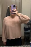 This shirt is appropriate for business casual (although not the most flattering) but the back is partially sheer so you will need an undershirt to wear with it. - Laura R.