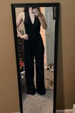 I love this jumpsuit. I just wish it fit better. I'm 5'4", pretty average height, and fully expected the need to wear heels for the pants to not be too long. But even with 3-4 inch heels, it's still dragging on the floor. It could be fixed with a hem, but the crotch is also about 2 inches too far down. I LOVE this jumpsuit, but wouldn't get it if you're shorter than ~5'6" (at this height, you'll still probably need to wear heels). At 5'4", it's just way too long. - Hunter H.