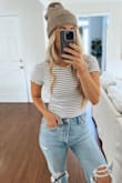 Runs a little small. I have a long torso and it definitely gave a wedgie when buttoned. The material is a little thinner than expected but the stripes make it flattering. - Christina L.