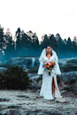 Wore this for my fall elopement at Sequoia, and it was an absolute dream. Completely fit the magical setting and for such an unbelievable price! Yes, the train did get leaves and twigs stuck all over it, but that's to be expected when traipsing through the forest. The sleeves are sooo dreamy. I couldn't stop draping them on everything throughout the day. Also, this dress will keep you warm - it is thick! Our first look was at sunrise. In the mountains/forest, it was a bit colder than the rest of California, but I stayed warm wearing this dress. I wore a bra with it. It was completely hidden underneath the lace, but I don't think a bra is necessary for everyone (I had just had a baby so wore one for my own comfort). As other reviewers mentioned, the only alterations I had done were attaching the lining to the dress and adding a bustle. I hand washed it after the wedding and picked out little twigs, and it looks good as new! - Tanwaporn O.