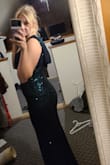 Was worried at first pulling it out of the bag. As it wasn't as green as I thought, and seemed like a different material. The dress is black but the sequins are green. I'm a Medium but a large in the hips. I risked getting a Medium and SO glad it stuck with that. The material is stretchy and VERY forgiving so I'm glad it is the type is it after looking back. The front doesn't expose too much either, so this worked well for my Christmas party. Would recommend! - Michaela P.