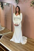 I absolutely loved this dress. I was between a Small and X Small. Ultimately, I went with the X Small, as there would be less alterations needed. I added some buttons on the sleeves and a belt, and I hemmed the length and sleeves as well. I felt beautiful and comfortable in the dress. This is perfect for the bride who is looking for elegance and simplicity. - Dana S.