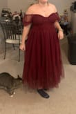The skirt of the dress is way more full than the photo suggests. There is a stiff layer of tulle that really rounds it out (I plan on cutting out that layer). The boning on the top of the dress is not the most comfortable and bows outwards for some reason but it isn't super noticeable. It's not really a midi dress in my opinion, but that might be due to my height. The sleeves look way better pulled up as shown on the model. - Veronica B.