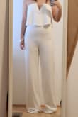 This jumpsuit was such a fun piece. I'm glad I tried it on, even though I didn't keep it. I'm very short so hemming was expected. The material was thin and slightly see-through. The bust stayed in place without a bra, but I only tried it on. Lower tummy and panty lines definitely show in this one, and it can fit tight around the crotch area. - Jamie L.