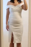 I usually go between small and medium tops. This small was definitely snug, and it did show a little tummy. It is a soft, thicker fabric so it kept me warm, and it is a true white color. You can't move your arms all the way up due to the straps, but it was comfortable. This was almost my elopement dress, but I changed my mind last minute because it was a little more formal than what I was going for. - Jamie L.