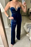 This jumpsuit is so fun and so comfortable. I love the color and it's so soft. It is a bit long even with heels & I probably will have to get it taken in around the back if I want to feel more secure in the bust. If I went down a size it might fit better in some areas, but then it might not be as comfortable/roomy in the legs and I don't like clothes too tight on my legs/bottom. Even though I'll have to alter it, I'm keeping it because it'll be really cute to wear for an evening out for the holidays! In the future, I should buy both sizes to compare but unfortunately, the S is sold out. - Laura B.