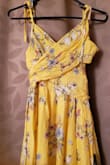 I like it. The pattern isn't as nice as I thought, which is why I took a star off. The front wraps down and behind to tie at the back. I'm usually in between a small and a medium, and the medium fit perfectly. - Nancy V.