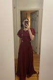 Love the sleeves and the neck of the dress, was worried that it was on the purple side however it is more red than purple. I am in between an xs and an xxs so it is a bit tight however that is better than it being loose in my experience - Fae W.
