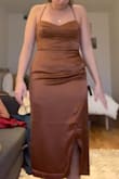 I think this dress fits true to size. I never buy this kind of style of dress but decided to take a gamble. It did not work for my body at all but if it's your style of dress could work for you! It felt particularly unflattering for my height and my butt. The quality of the material is average. - Megan M.