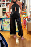 Never in a million years did I think I could rock this kind of jumpsuit because I'm not perky on top and can't trust that this would stay on, but it does AND it looks great! It's such a fun jumpsuit. I simply felt great in it. I ordered a size smaller to make sure the top would be secure. It was a bit tight on the bottom & rode up in the crotch area, but it was worth that discomfort because it is such a stylish piece. It also isn't pleasant to get on or off, but it wasn't a dealbreaker. Awesome jumpsuit for Xmas or a New Year's party! Go for it! - Marline K.