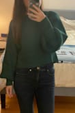 I fell in love with the color and fit the moment I saw this sweater, and I just had to buy it! This is the perfect color sweater for the holidays; I would say that it's more in-between an emerald green and a forest green. It runs true to size. I probably could have sized down to an XS, but I chose the S because I wanted it to be comfy and a little longer since it is cropped. I think if I chose an XS, it might be a little too short! Definitely a sweater to wear with high-waisted pants, or at least midrise. My arms are definitely shorter than the model, but I think the sleeve style is still super cute! The fabric is also super soft and very stretchy. I fell in love with it the moment I put it on! Definitely would recommend. - Keilani F.
