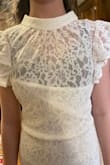 We really wanted to love this dress. It's beautiful right out of the bag. The bodice was very long leaving my daughter's bra/chest exposed. The hip section of the dress was snug. Fit oddly, but the material and lace were of good quality. We returned. She usually wears an XS and we ordered an XS. - Kristie G.