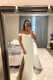 I took a chance ordering this dress with no reviews. I originally ordered xs according to the size guide, but the dress wouldn't zip up. I exchanged it for a small, and the dress still wouldn't zip up all the way. For reference, I'm slender, 5'1 and 113 pounds. Finally, the medium fit! It has a beautiful small train, but I'll have to hem the dress since I'm short. The only downside is you can't lift your arms up high without restriction because of the sleeves, but it's not a deal breaker. Overall I love how simple and elegant the dress is! - Allyson F.