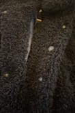The jacket is soft and pretty warm. A little on the boxy side yet oddly tight through the back. Sadly, it arrived with the middle button detached so I sewed it back in then the other side of the snap came off too. Not the best quality for sewing the buttons. - Paula V.