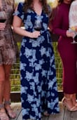 I love this dress and have received so many compliments on it! It's a true wrap dress. I've worn it a few times now, and, other than the top being a little low for me (I had to get a snap for the top), it is great. You do have to watch out for the slit, but it's not too bad. - Kayla W.