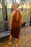 This dress was definitely fitted and bodycon style all the way. The neckline was perfect for an updo and I loved the slit from the neck down the back. Sexy but not revealing in any way.  This dress was actually comfortable and had enough stretch to dance the night away. The color was beautiful for a fall wedding. I got tons of compliments and even the photographers gave out a few compliments. Don't get this dress if you don't want form fitting but if you do then this dress is the one!! - Alicia J.