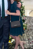 I wore this to a work holiday party, and it was perfect. It was cute. The cutouts made it just a little sexy; it wasn't tight anywhere. The material on the outer layer does stain very easily. I got a couple drops of water on the upper half, and even when it dried, it left a mark. Also, the underlayer was seemingly assembled inside out. The finished seam was facing in while the surged seam was facing outside. You can't see this because the upper layer covers it, but it is interesting - Janie P.