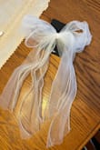 I got this bow with my bachelorette party in mind! It's so cute to wear on its own but will also be the perfect mini veil! Love how fluffy and long it is! - Megan V.