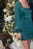 The dress was super cute. A little loose on the sleeves so I had to tape them, but I wouldn't have sized down because it fit my hips well. - Leah R.