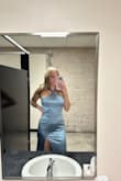 I loved this dress! It's super stretchy and flattering. I wanted to wear shapewear/a bra, but it does show every crevice. I ended up wearing just thin underwear underneath. The material was thick enough to hold it together. It was a little short on me, but I'm 5'10 without heels. - Laura D.