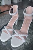 I scoured the internet looking for the perfect wedding shoe, but could not find one that checked ALL of my boxes: white, 3" height, block heel (for grass), comfortable, affordable, AND adorned with pearls. Lulus shoes have always been very comfortable for me and this shoe fit all of the criteria EXCEPT the pearls. So, I purchased a $10 pearl kit on Amazon, some JB weld super glue and got to work making myself exactly what I wanted! It took about 3 hours total (1.5 hours for each shoe) and they turned out AMAZING! :) - Melissa L.