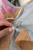 The first time I tried the dress on, it fit perfectly so I packed it for my honeymoon. The second time I put it on, the inside button fell off- without pressure being put on it, and the top clasp ended up falling off as well. I was very sad that the dress literally fell apart within minutes. - Cali C.