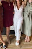 I wore this jumpsuit for my bridal shower this fall and absolutely loved it! I did need to get the straps shortened since I am only 5'2" so that helped (it is pretty low cut). The length was good, I did not need to get it hemmed. - Emily D.
