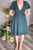 The dress is as described and as seen in the pictures. I was a little surprised by how heavy it was, but I guess that makes sense given the full lining. Notice that even though the listing says "May be worn with any standard bra", that didn't seem to be the case with me. I tried it on with two different types of bras and both show up as the cleavage is too low. I have small breasts and will probably wear it with just nipple covers (simple stickers).
Otherwise, it's nice, although I wish it were shorter as I feel like above-knee length suits me better. It is possible to slightly adjust the length by tucking it under the belt. - Sofie H.