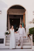 Bought this dress for my wedding in the Bahamas which was on a small budget. I felt so beautiful and absolutely loved it. Even at its low price, I didn't feel like I compromised on my dress at all. The vibe was casual elegance which fit perfectly. The polyester material has a pretty sheen to it that makes it look more expensive than what it is (polyester). I did have a seamstress remove the pockets since you could see them through the dress (Lulus offered a partial refund for my dissatisfaction with the pockets which I appreciated), and add buttons in the back, and hem. Since I'm short I could have added a small train with the hem but I wanted my dress train-less since we were outside and in and out of golf carts all day. My wedding was a super windy day and I was worried about the slit in the dress but it was never an issue! I'll let the pictures speak for themselves. - Katie D.