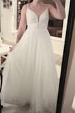 It's a beautiful dress. It's a little tight and I'll need to have it taken out. The straps are also very thin and dig into my shoulders. However, I love the dress and just need to alter it! - Adri M.