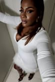 The dress hugs curves. It is beautiful and fits well. However, the feathers will get on your seat. The bottom is tight and does restrict dancing a bit. - Roxanne W.