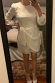 It fits true to size and is flattering on the waist, but it is a strange material. The high neckline isn't for me and a bit too plain. - Amber S.