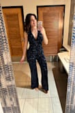 This jumpsuit was a showstopper for NYE! I usually get medium from Lulus, but this one was a little big. I am pear shaped, so I got it taken in at the top, and once I did it was perfect. It's pretty low cut so you'd either want to go braless or get a low cut halter bra. I'm also tall, but this was perfect length even with heels! - Megan O.