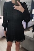 I'm starting to see that I'm probably between a size small and medium on Lulus product but based on the sizing chart. It shows I should be a medium. So, it's a little frustrating as this is a little large in the waist for me. Even elasticized, I have a couple of inches. I do think it's pretty cute though and will keep the sizing. It did need a few thread cleanups as the was a serger line exposed at the waist and loose threads on cuffs etc. The front lacing was a little more revealing than I had anticipated based on reviews and photos so I would likely wear a nude colour tank top or bandeau if I wear it with a blazer for work. I do like that it's below my fingertips in length (even with my long nails) to keep it appropriate. - Tracie R.