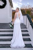 I was not looking to spend thousands of dollars on a dress, so for the price & detailing of this dress I couldn't go wrong! I was surprised that this dress was quite heavy. I loved that it had some weight to it for our November wedding. The beaded detailing made the dress look more expensive than what it was. I will say though that every time I tried it on, I'd leave a trail of beads everywhere. So in that sense, it was a bit cheap. Even though a lot fell off during all my try ons it never looked like there were gaps or holes. I sized down from a S to XS & it fit so much better. I never needed to get it hemmed shorter. Minus losing beads, the only c/o I had was that the arm holes are a bit snug. I had to have the straps altered & the arm holes let out because it was too tight. There also is no bustle, so I did have to have it altered for that too. Overall, it was a beautiful dress & I was happy with my choice! - Laura B.