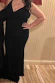 The fabric was stretchy! I'm also usually a size 12/14 jeans. So, once I was able to figure out the straps in the back and slide it on, it fit like a glove! I do recommend maybe sizing up to put a shaper underneath. I did not. It still fit well and was flattering. My back rolls were a little bulgy but it was fine. - Denise E.