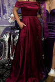 I loved the dress. I didn't have time to get it altered but I would definitely say it ran a bit longer than what I was expecting. I'm 5'5 and wore 1 1/2-inch heeled boots. Maybe I just don't know how to walk in a dress but either way, I loved it. It even had pockets! (A little more pink in natural sunlight, deeper red in the darker lighting). - Jamie F.