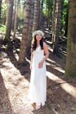 I ordered 3 dresses for my elopement and fell in love with this one! The lace back detail is stunning and it's a zip up so you don't need to worry about those buttons. I had to get it hemmed about 3 inches. It is very long and I didn't want it dragging on the floor. It's very flowy and doesn't hug my stomach or butt so I didn't have to worry about shapewear. I wore nude underwear and shorties that showed in other dresses but not this one because it has three layers! I wore a medium and it wasn't too tight. It was perfect. I felt so beautiful on my wedding day! - Aimee N.