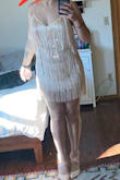 Great dress! Super fun and flirty. It's tight, but the fringe hides the tum real well. It is wildly short (can't bend over), but the fringe at the bottom makes it more appropriate. - Nat S.
