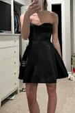 I really wanted to love this dress. The material is satiny, and the structure of the dress is great. It looks amazing on. Unfortunately, it was too big in the bust/corset. I'm not sure if I would say it runs large, but it definitely doesn't run small. I would need an XXS in this. Sad to see this one go back. If you're fuller up top, it may work for you! - Leah G.