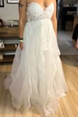 This was my least favorite dress in person. I did order a size Medium and could not zip it up. I didn't really like the way the organza laid and barely noticed the accent embroidery. I know I had to steam it, but regardless it didn't make me want to exchange it for a Large, instead I returned it. - Diana C.