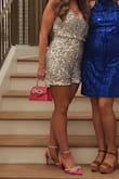 I purchased this for a Studio 54-themed Mom Prom. I read the reviews and opted to size up because I am in my 40s and needed it to be a little longer and not too snug. A medium was perfect. I did need to get the sides under my armpits taken in, but otherwise, it was perfect. It wasn't itchy as others reported - it's completely lined. Also, the sequins have this pink sheen to them, so I paired the romper with hot pink shoes - it looks AMAZING. Some of the sequins fell off, but given the price, it's a great buy. - Shannon R.