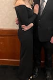 The material is great quality and has a nice stretch to it. I was worried about the front sliding down, but it has a gripper strip that keeps it secure. Length was perfect at 5'6 and 2 inch heels. Really flattering. Slit would rise a bit when I walked, so I had to give it a tug down once in a while. - Lacey W.